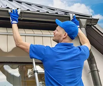 Metal roofing Clarksville guy inspecting roof