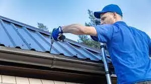 Metal Roofing Clarksville man inspecting a roof